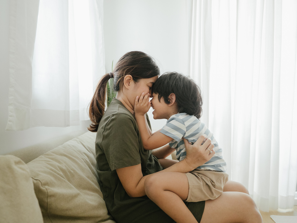 Millennial asian parent at home.